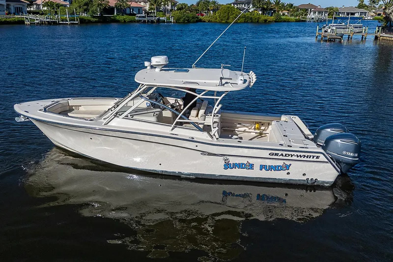 Sundae Funday Yacht Photos Pics 2017 Grady-White Freedom 307 boat on calm water, side view.