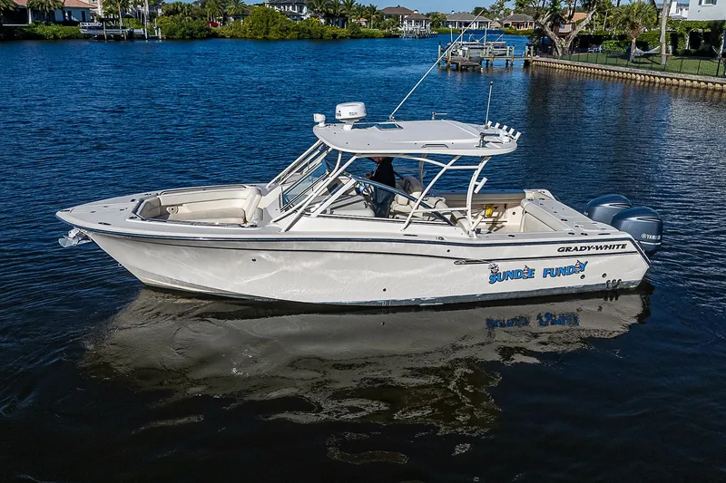 Sundae Funday Yacht Photos Pics 2017 Grady-White Freedom 307 boat on a serene waterway.