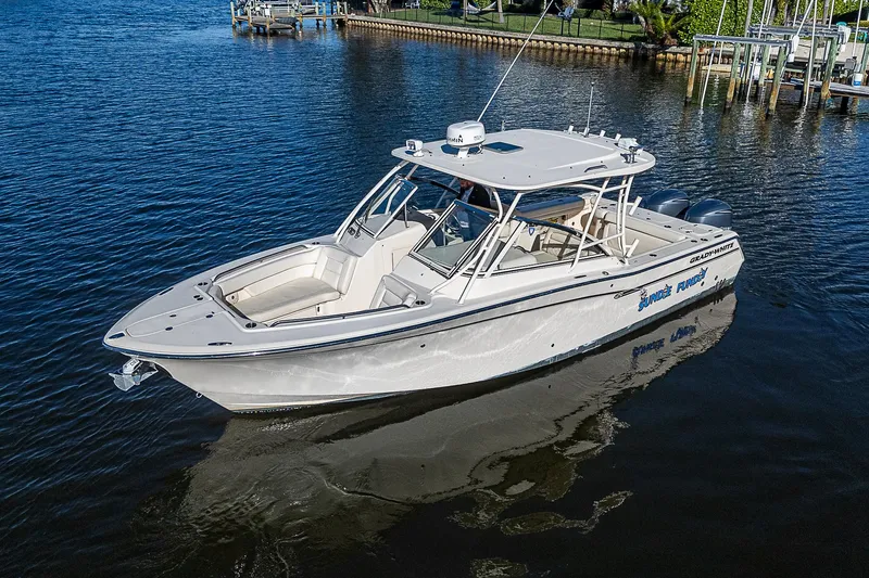 Sundae Funday Yacht Photos Pics 2017 Grady-White Freedom 307 boat on calm water, showcasing sleek design and spacious deck.