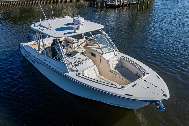 Sundae Funday Yacht Photos Pics 2017 Grady-White Freedom 307 boat on calm water, showcasing sleek design and spacious seating.