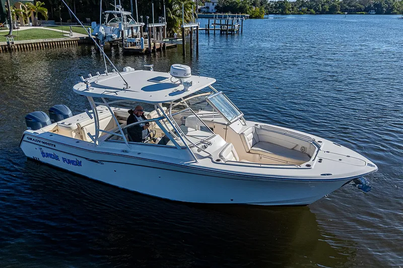 Sundae Funday Yacht Photos Pics 2017 Grady-White Freedom 307 boat cruising on a calm lake.