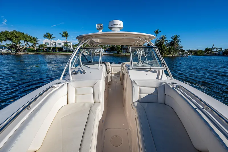 Sundae Funday Yacht Photos Pics 2017 Grady-White Freedom 307 boat on calm water, clear sky, and palm trees in background.