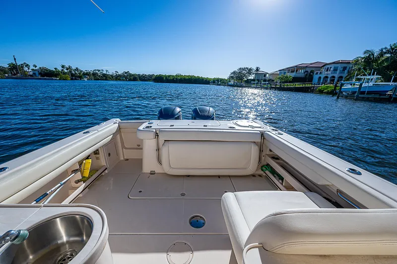 Sundae Funday Yacht Photos Pics 2017 Grady-White Freedom 307 boat on serene water with clear blue sky.