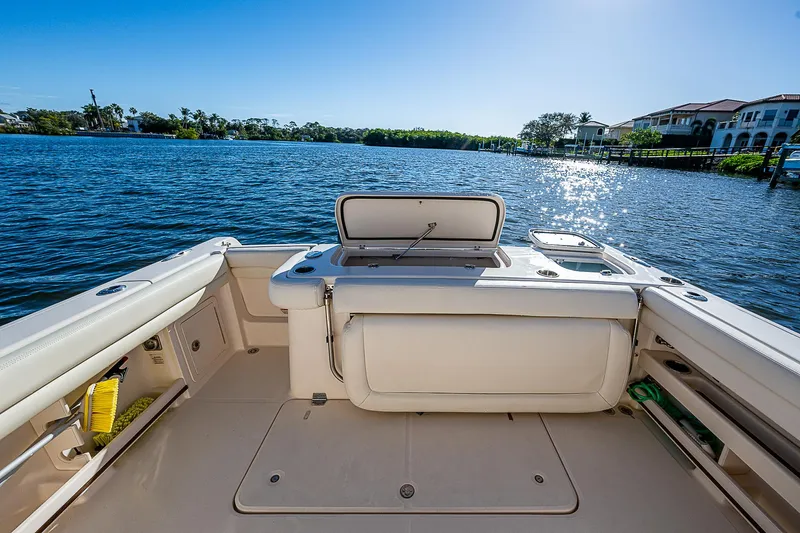 Sundae Funday Yacht Photos Pics 2017 Grady-White Freedom 307 boat interior with open storage, overlooking serene waterfront.