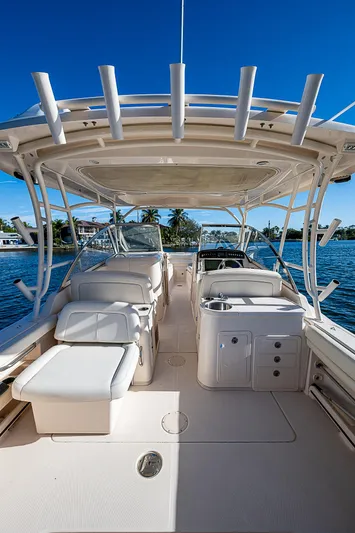 Sundae Funday Yacht Photos Pics 2017 Grady-White Freedom 307 boat interior with seating and helm, under clear blue sky.