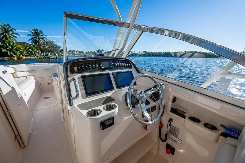 Sundae Funday Yacht Photos Pics 2017 Grady-White Freedom 307 boat interior with steering wheel and navigation screens.