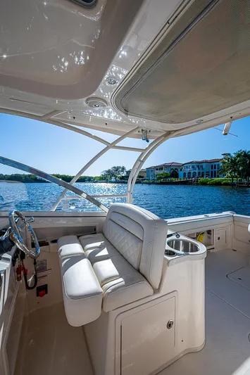 Sundae Funday Yacht Photos Pics 2017 Grady-White Freedom 307 boat interior with seating, overlooking serene waterfront.