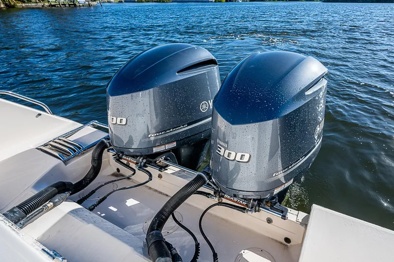 Sundae Funday Yacht Photos Pics Twin outboard engines on a 2017 Grady-White Freedom 307 boat, on a calm lake.