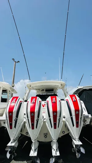 Twin J Yacht Photos Pics 2021 Boston Whaler 420 Outrage with four powerful outboard engines, under a clear blue sky.