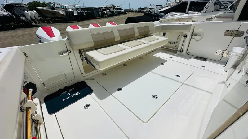 Twin J Yacht Photos Pics 2021 Boston Whaler 420 Outrage boat deck with seating and storage compartments.