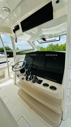 Twin J Yacht Photos Pics 2021 Boston Whaler 420 Outrage helm with modern controls and steering wheel.