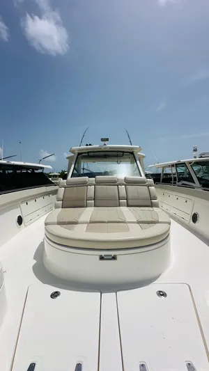 Twin J Yacht Photos Pics Boston Whaler 420 Outrage 2021 boat with spacious seating under a clear blue sky.