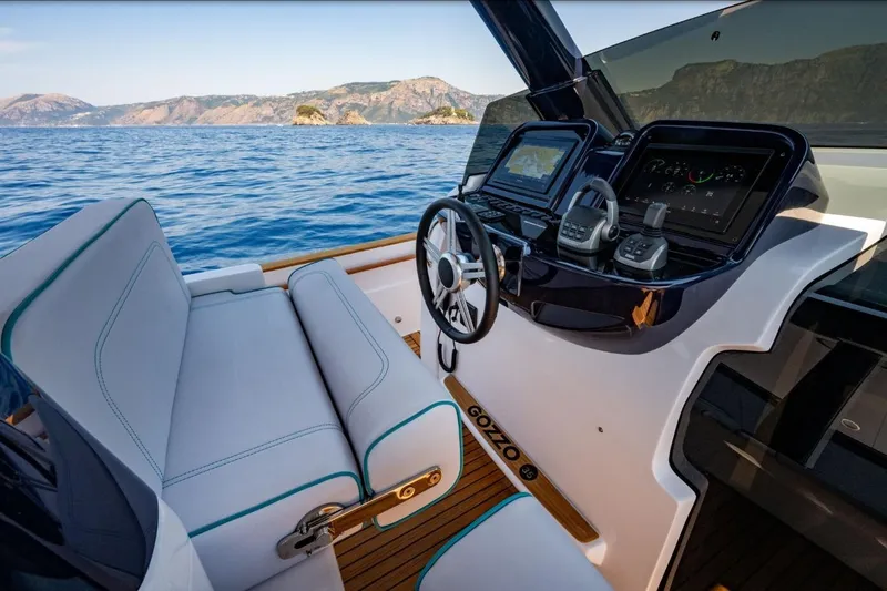  Yacht Photos Pics 2025 Apreamare GOZZO 35 yacht cockpit with modern controls, steering wheel, and scenic ocean view.