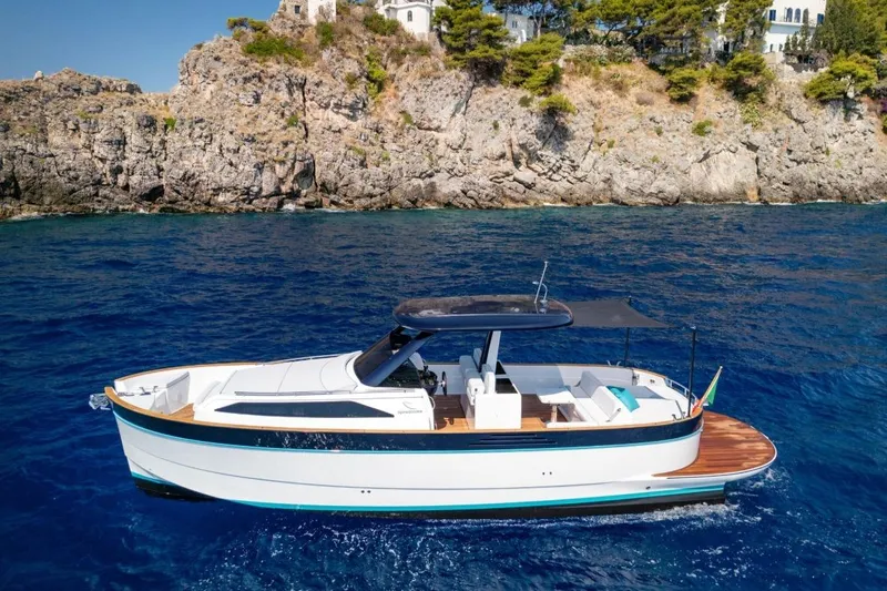  Yacht Photos Pics 2025 Apreamare GOZZO 35 yacht cruising near rocky coastline.