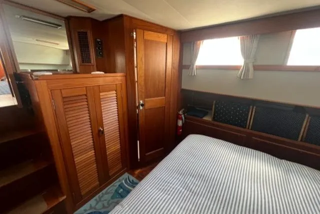 Lan Mara Yacht Photos Pics 1987 Grand Banks 42 Classic Trawler interior with wood paneling, bed, and windows.