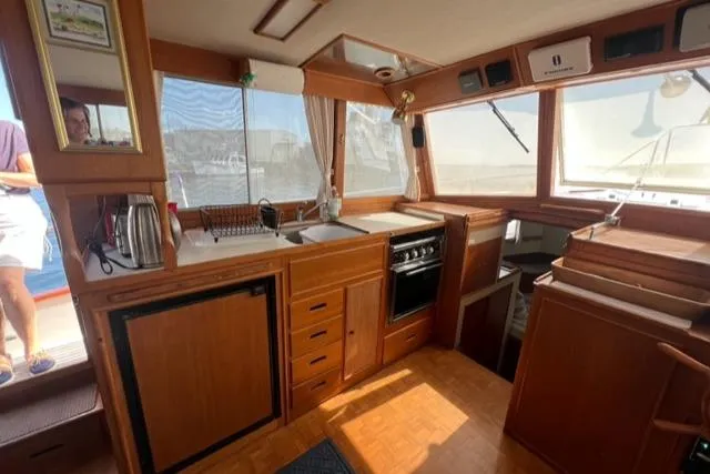 Lan Mara Yacht Photos Pics 1987 Grand Banks 42 Classic Trawler interior with wood cabinetry and kitchen appliances.