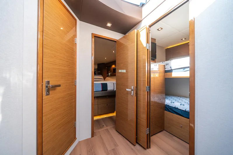 Risky Business Yacht Photos Pics Luxurious 2019 Cruisers Yachts Cantius interior with wooden doors and cozy cabin beds.