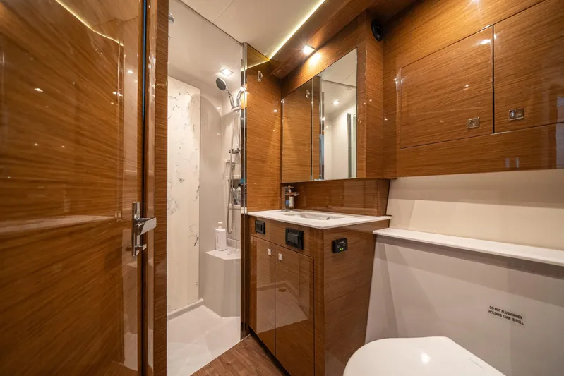 Risky Business Yacht Photos Pics Luxurious 2019 Cruisers Yachts Cantius bathroom with wood finish and modern amenities.