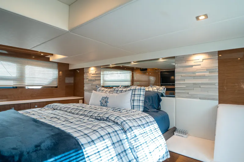 Risky Business Yacht Photos Pics Luxurious bedroom interior of 2019 Cruisers Yachts Cantius with modern decor and cozy bedding.