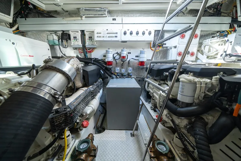 Risky Business Yacht Photos Pics Engine room of 2019 Cruisers Yachts Cantius, featuring Cummins Onan generator and advanced machinery.