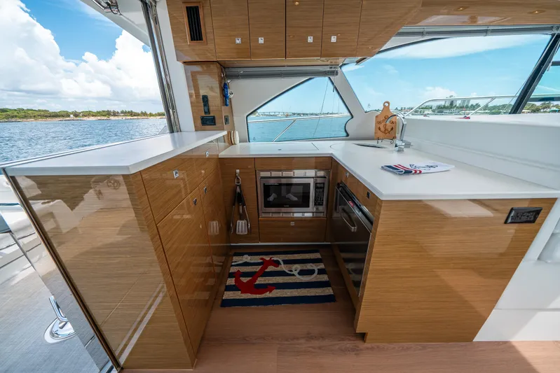 Risky Business Yacht Photos Pics Luxurious 2019 Cruisers Yachts Cantius kitchen with modern appliances and scenic ocean view.