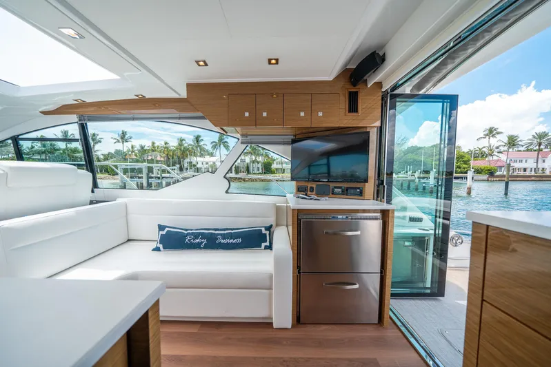Risky Business Yacht Photos Pics Luxurious interior of 2019 Cruisers Yachts Cantius with modern design and waterfront view.