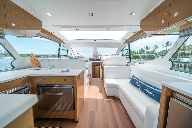 Risky Business Yacht Photos Pics Luxurious interior of 2019 Cruisers Yachts Cantius with modern kitchen and seating area.