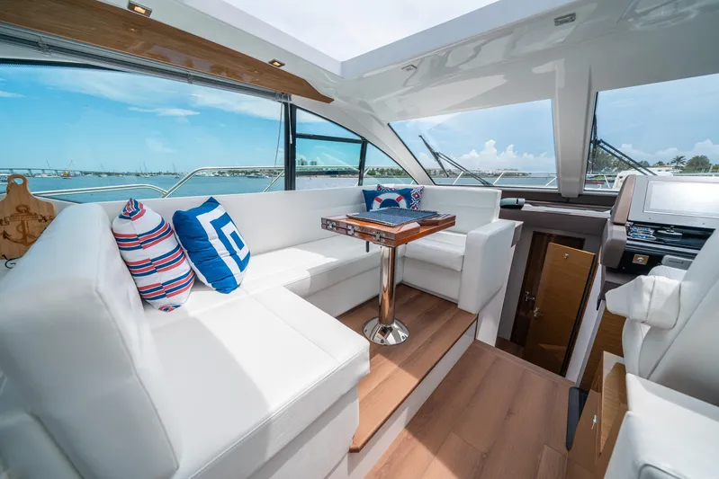Risky Business Yacht Photos Pics Luxurious 2019 Cruisers Yachts Cantius interior with plush seating and nautical-themed decor.