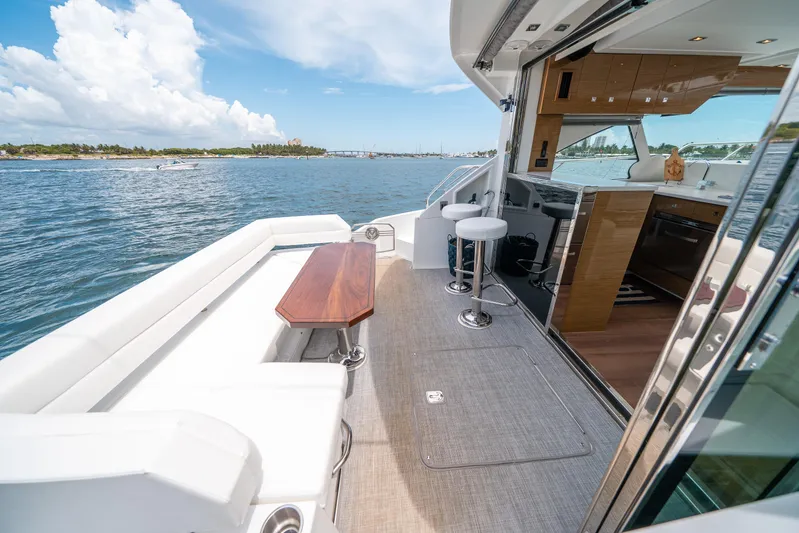 Risky Business Yacht Photos Pics 2019 Cruisers Yachts Cantius deck with seating, ocean view, and modern interior.