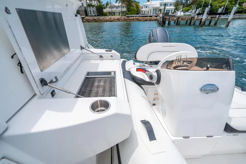 Risky Business Yacht Photos Pics 2019 Cruisers Yachts Cantius boat interior with grill and steering console.