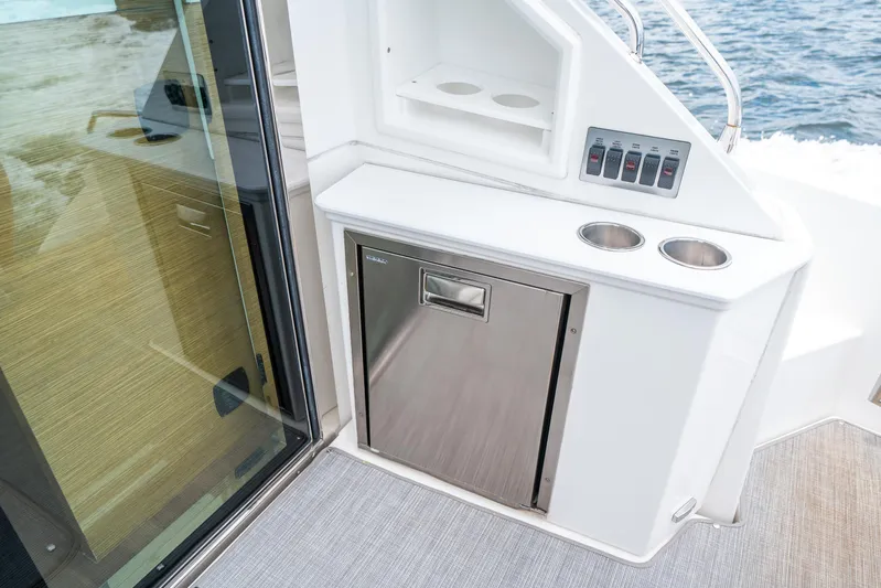 Risky Business Yacht Photos Pics 2019 Cruisers Yachts Cantius interior with stainless steel fridge and control panel.