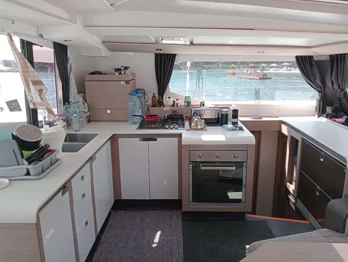  Yacht Photos Pics Modern kitchen interior of 2023 Fountaine Pajot Tanna 47 yacht with scenic window view.