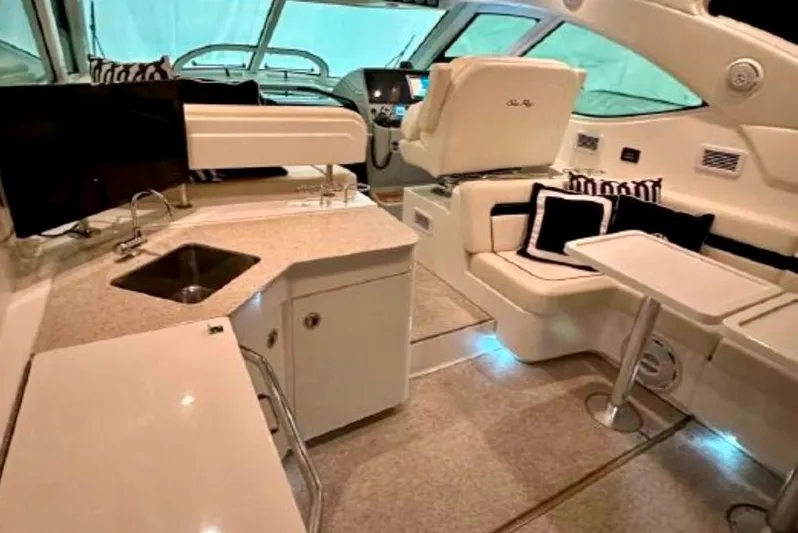  Yacht Photos Pics Luxurious interior of 2011 Sea Ray 470 Sundancer yacht with modern seating and kitchenette.