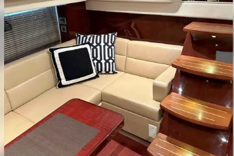  Yacht Photos Pics Luxurious interior of 2011 Sea Ray 470 Sundancer with beige seating and wooden stairs.