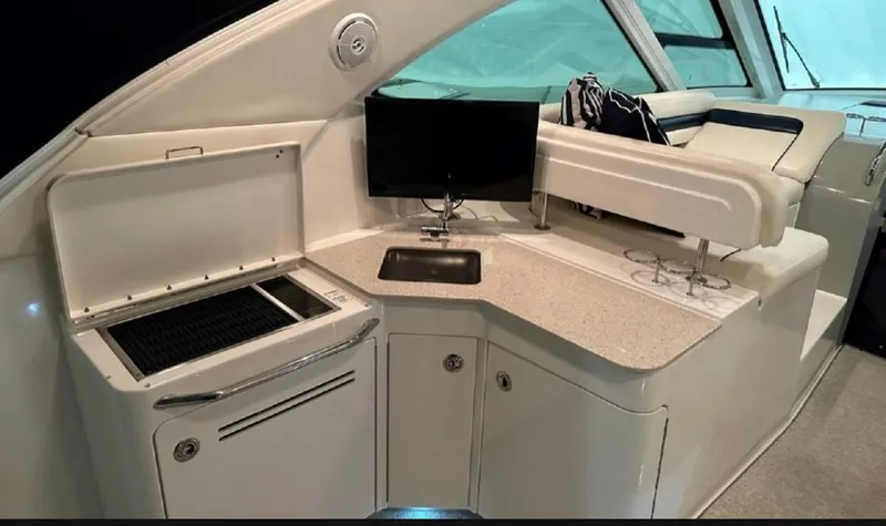  Yacht Photos Pics Interior of 2011 Sea Ray 470 Sundancer yacht with kitchenette and seating area.