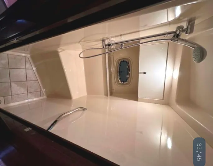  Yacht Photos Pics Interior shower of 2011 Sea Ray 470 Sundancer yacht, featuring modern fixtures and porthole window.