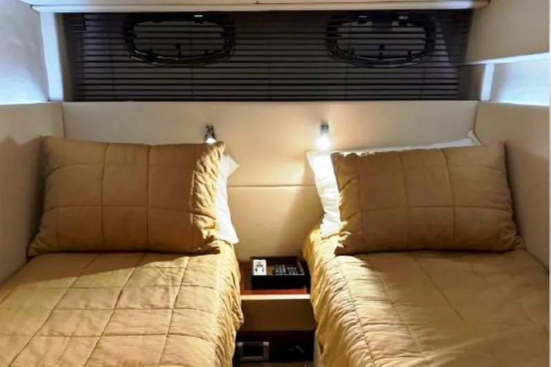  Yacht Photos Pics Twin beds in the 2011 Sea Ray 470 Sundancer cabin, featuring cozy beige bedding.