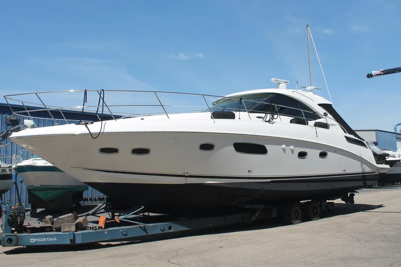  Yacht Photos Pics 2011 Sea Ray 470 Sundancer yacht on trailer, docked outdoors under clear blue sky.