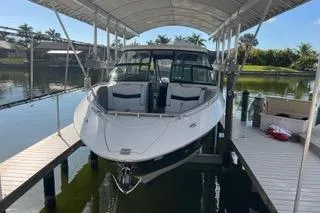  Yacht Photos Pics 2023 Four Winns H350 OB boat docked under a canopy on a sunny day.