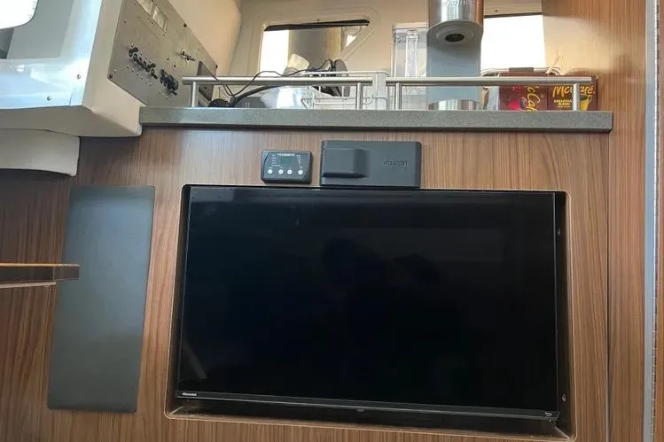  Yacht Photos Pics Interior of 2023 Four Winns H350 OB boat with mounted TV and control panel.