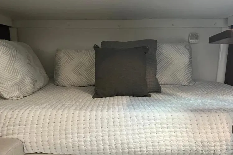  Yacht Photos Pics Cozy cabin bed in 2023 Four Winns H350 OB boat with decorative pillows.