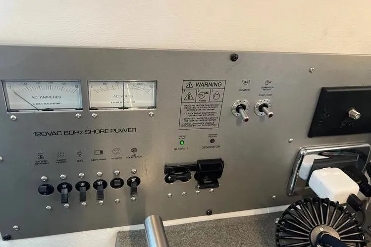  Yacht Photos Pics Control panel of 2023 Four Winns H350 OB boat with shore power indicators and switches.