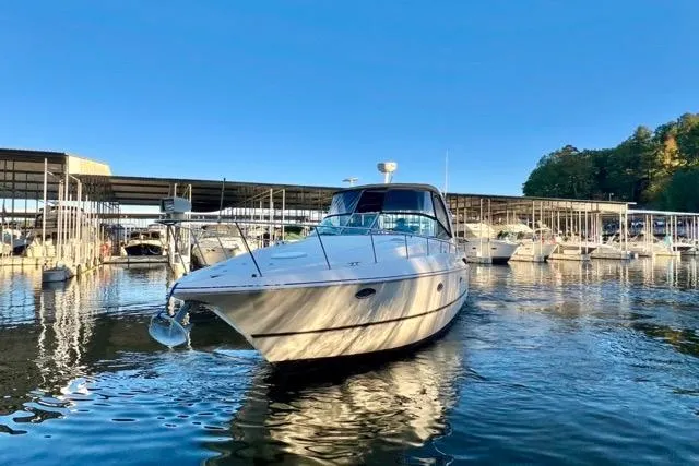 Partner Ship Yacht Photos Pics 2003 Cruisers Yachts 3772 Express in marina, reflecting on calm water under clear blue sky.