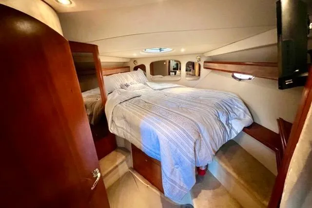 Partner Ship Yacht Photos Pics Luxurious cabin interior of 2003 Cruisers Yachts 3772 Express with cozy bed and wooden accents.
