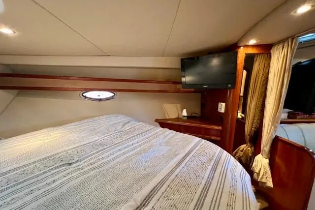 Partner Ship Yacht Photos Pics Interior cabin of 2003 Cruisers Yachts 3772 Express with bed and TV.