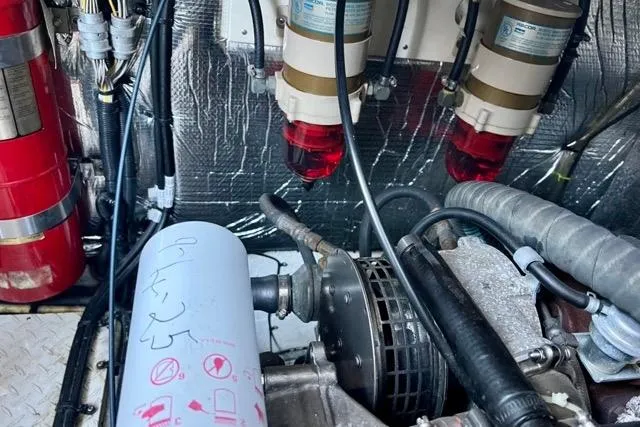 Partner Ship Yacht Photos Pics Engine room of 2003 Cruisers Yachts 3772 Express, featuring filters and fire extinguisher.