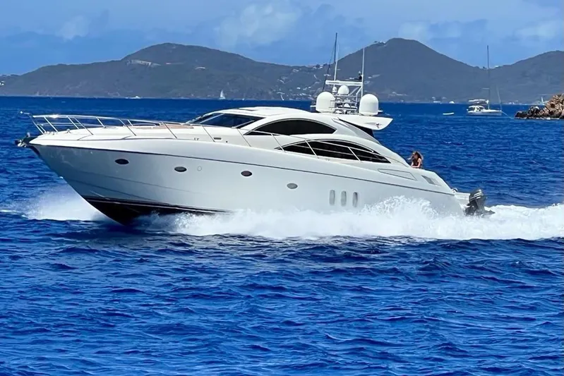 Relentless Yacht Photos Pics 2009 Sunseeker Predator 62 yacht cruising on blue ocean waters.