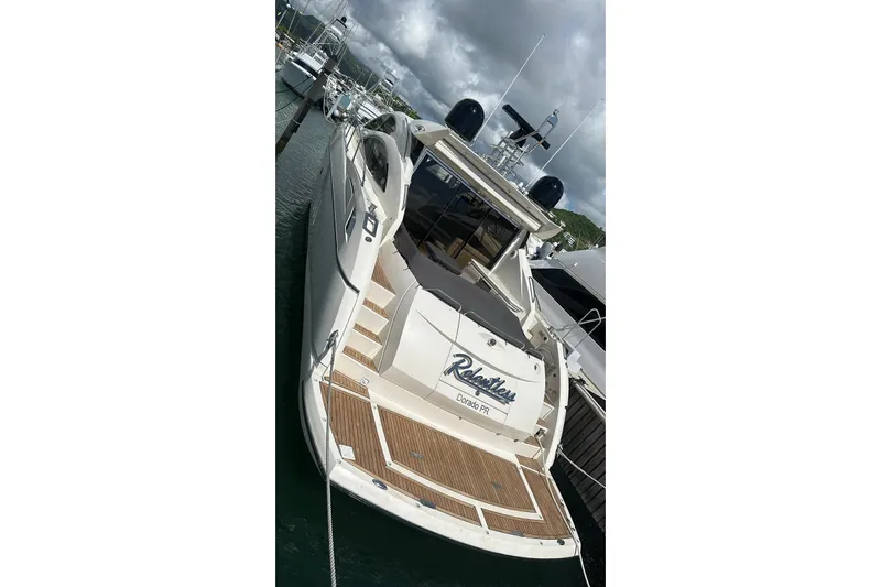 Relentless Yacht Photos Pics 2009 Sunseeker Predator 62 yacht docked, showcasing sleek design and spacious deck.