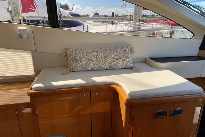Relentless Yacht Photos Pics Interior seating area of 2009 Sunseeker Predator 62 yacht with cushion and window view.