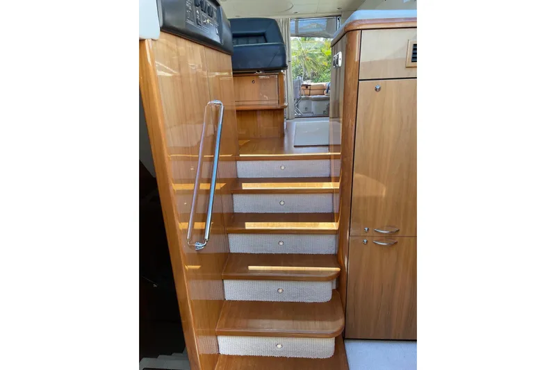 Relentless Yacht Photos Pics Interior stairs of 2009 Sunseeker Predator 62 yacht with wooden finish.